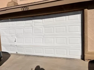 el paso garage door repair before - visble dents at the lower part