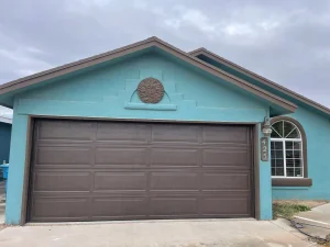 el paso garage door repair residential door 1 - dark brown panels on a teal painted home