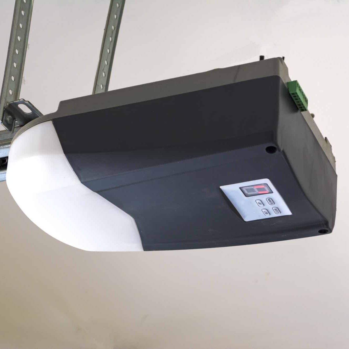 Close-up of an automatic garage door opener motor on the ceiling.